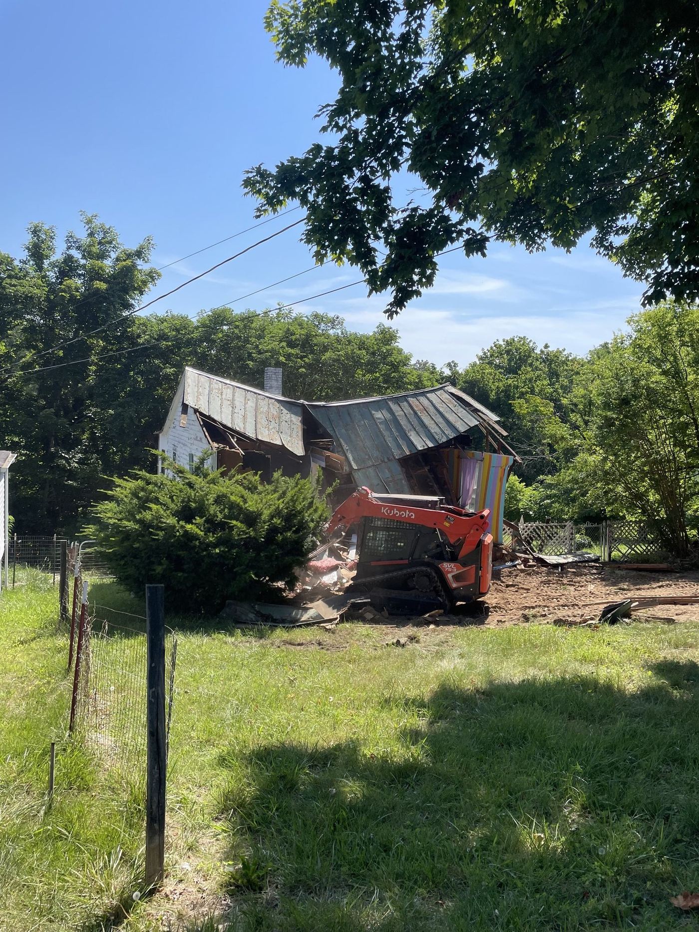 Skid steer taking down a house during a teardown